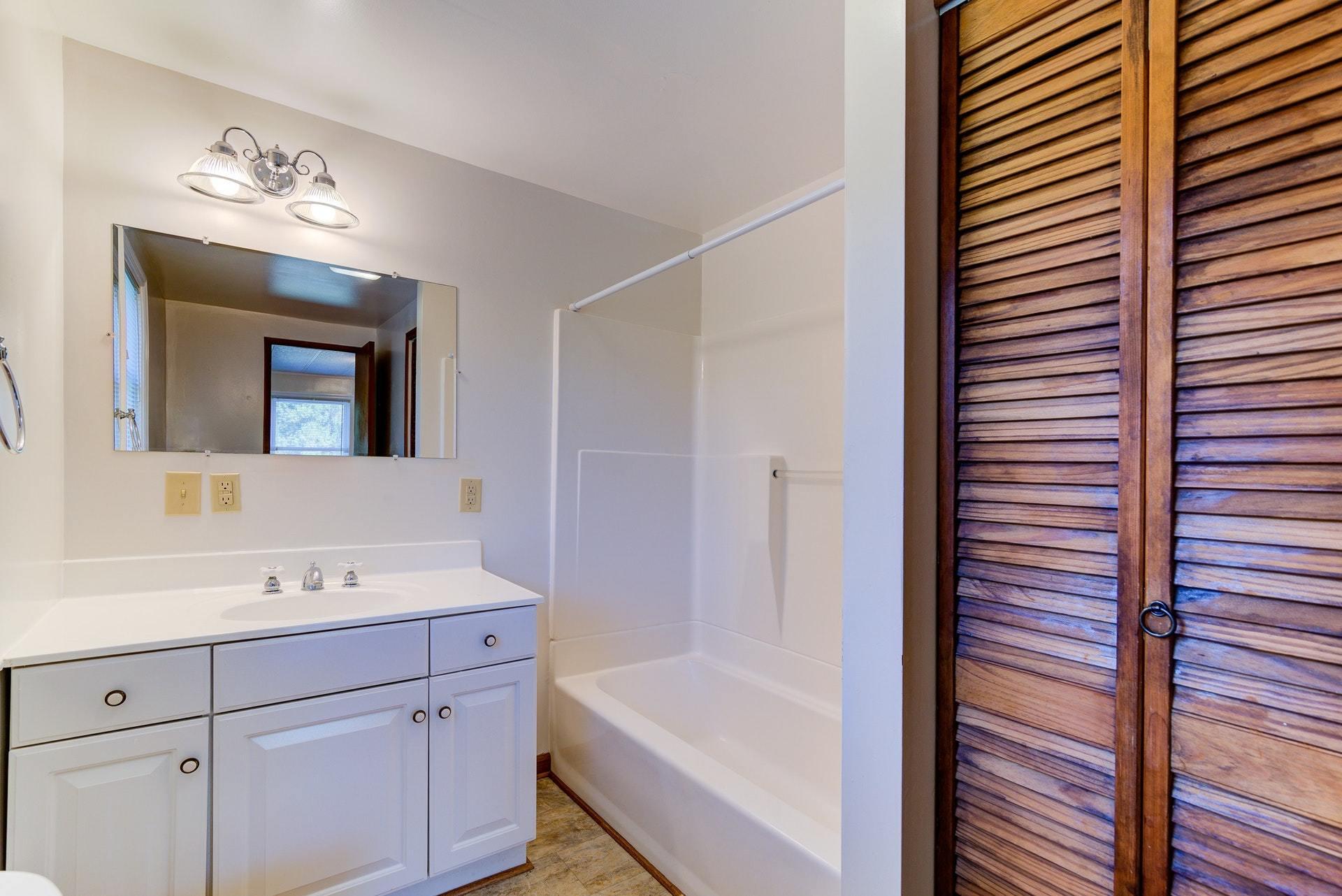 1103 Milton Road Blue Ridge, VA 24064 - Photo 18 of 29 a bathroom with a tub sink and mirror