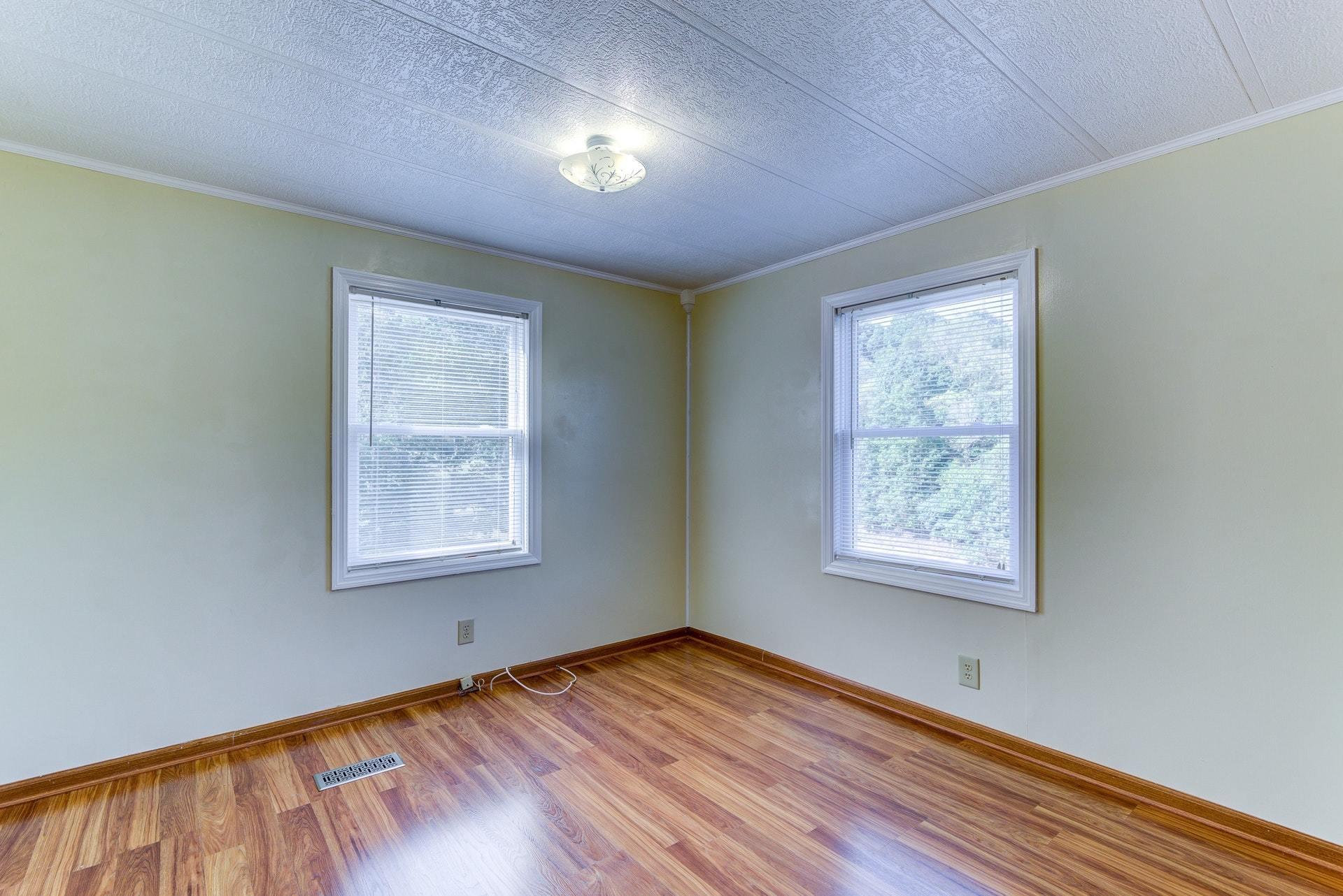 1103 Milton Road Blue Ridge, VA 24064 - Photo 19 of 29 an empty room with wooden floor and windows