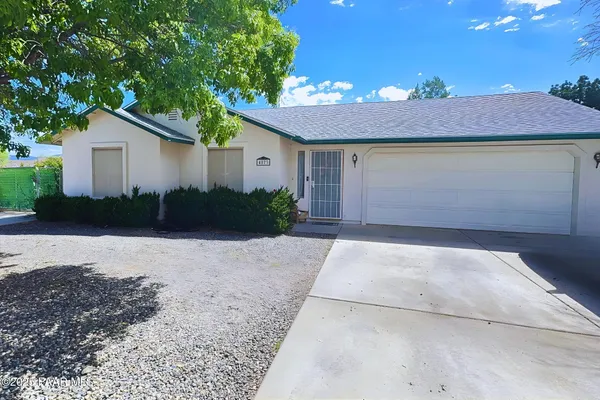 a view of a house with a yard and garage