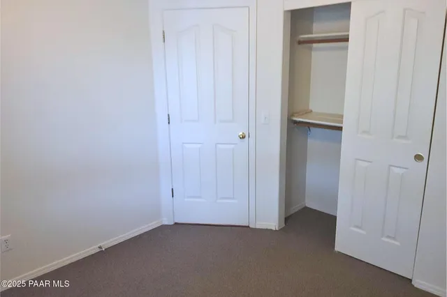 an empty room with closet area