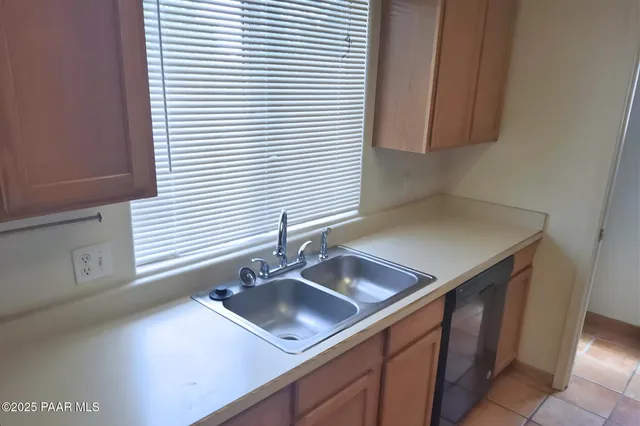 a kitchen with a sink and a window