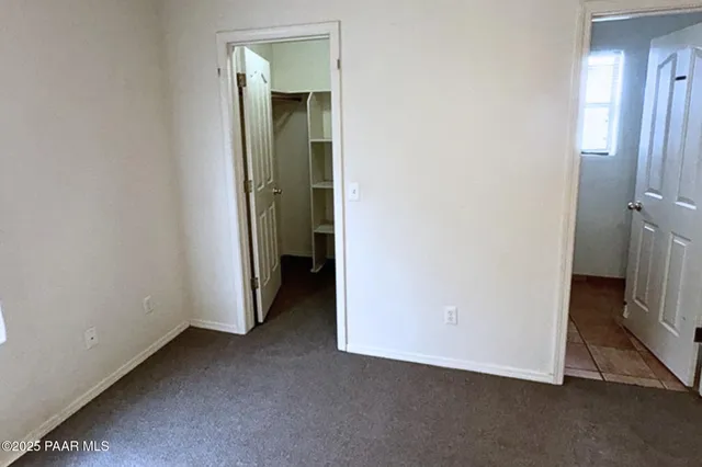 an empty room with a bathroom and a sink
