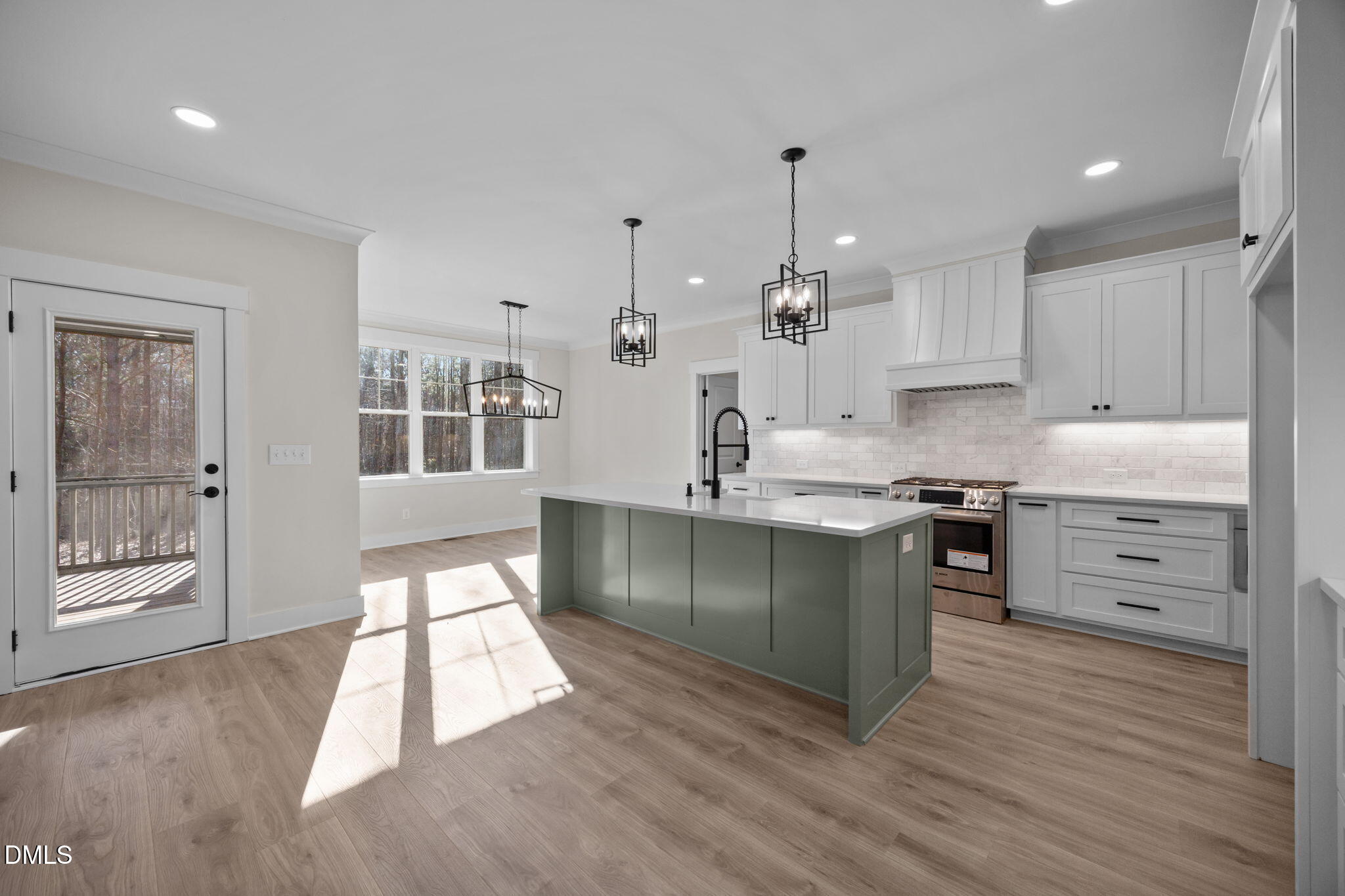 357 Slocum Drive Wendell, NC 27591 - Photo 11 of 48 a kitchen with stainless steel appliances kitchen island granite countertop a refrigerator a sink a stove and white cabinets with wooden floor