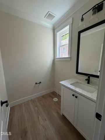 a bathroom with a granite countertop sink toilet and mirror