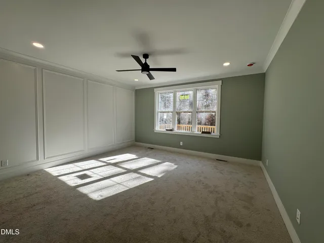 a view of a livingroom with a ceiling fan and window