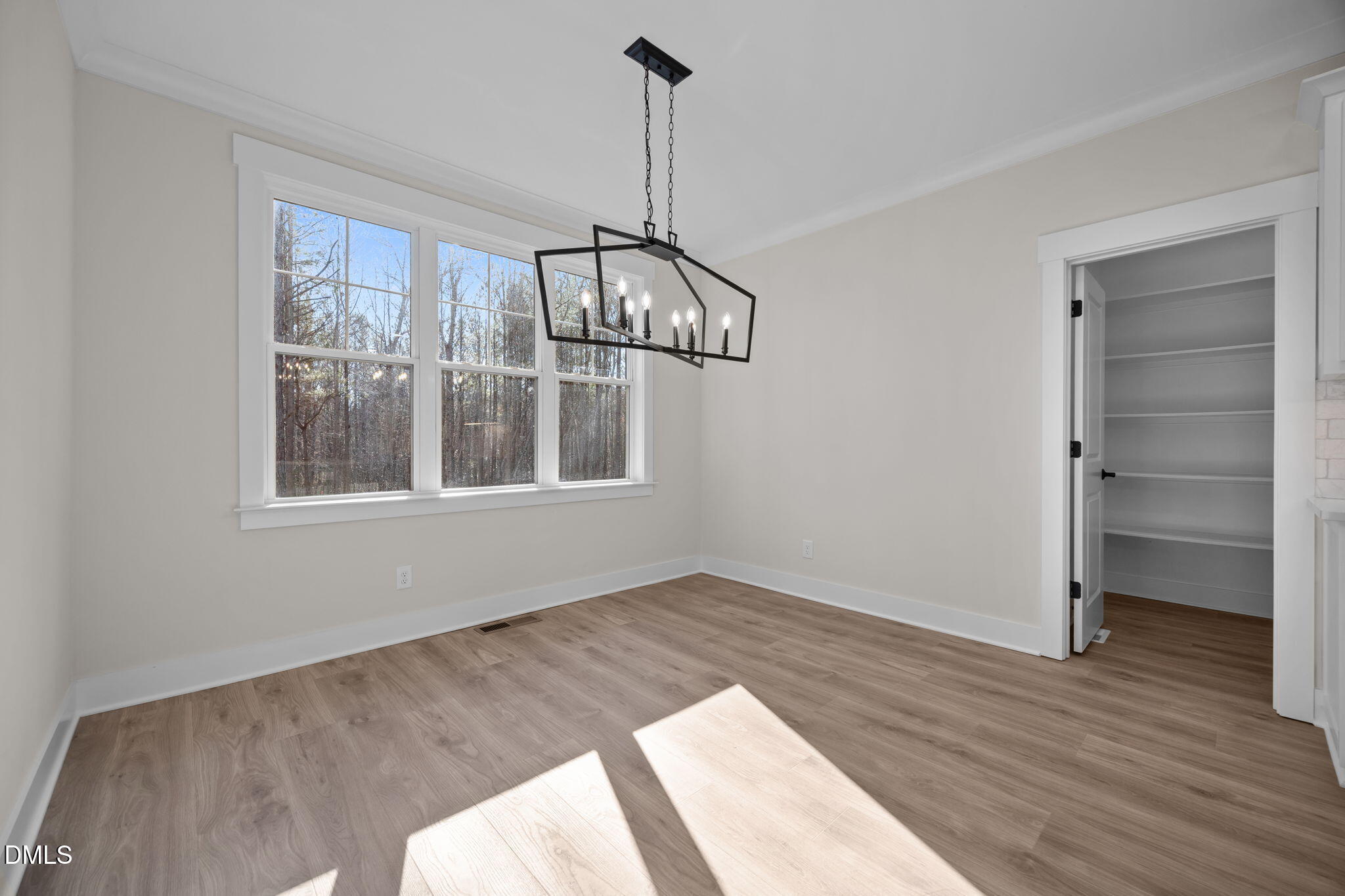 357 Slocum Drive Wendell, NC 27591 - Photo 18 of 48 a view of an empty room with a window and wooden floor