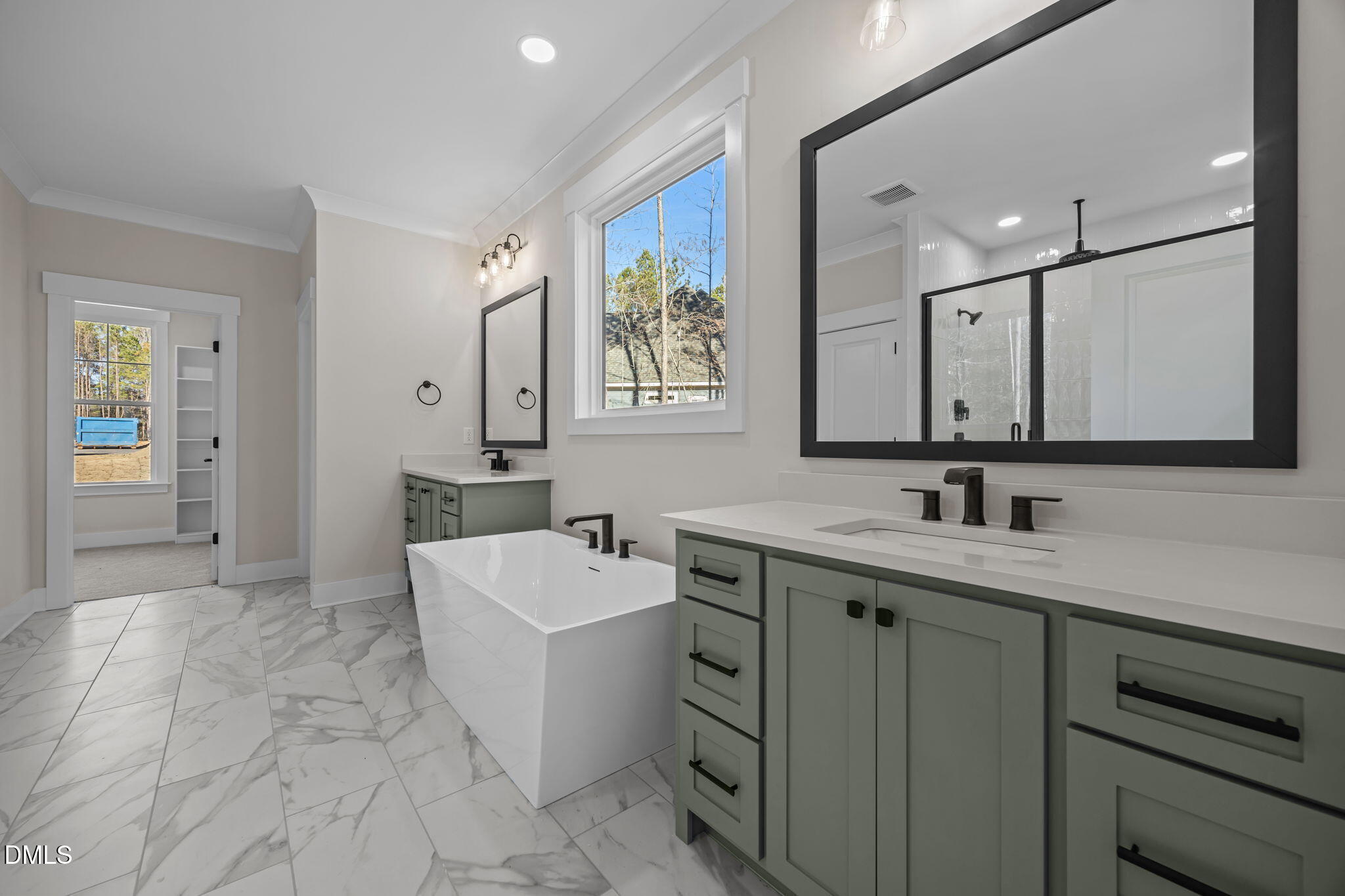 357 Slocum Drive Wendell, NC 27591 - Photo 22 of 48 a spacious bathroom with a double vanity sink a mirror and a bathtub