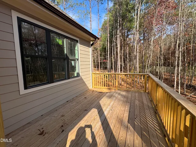 a view of a balcony with a floor to ceiling window and wooden floor