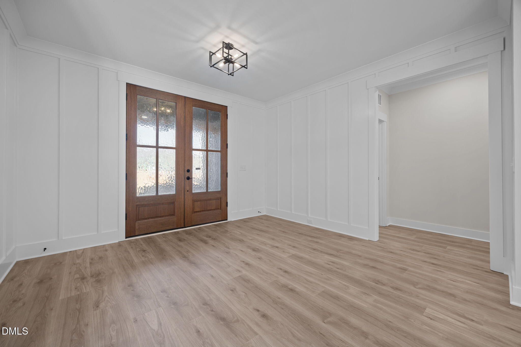 357 Slocum Drive Wendell, NC 27591 - Photo 6 of 48 a view of an empty room with wooden floor and a window