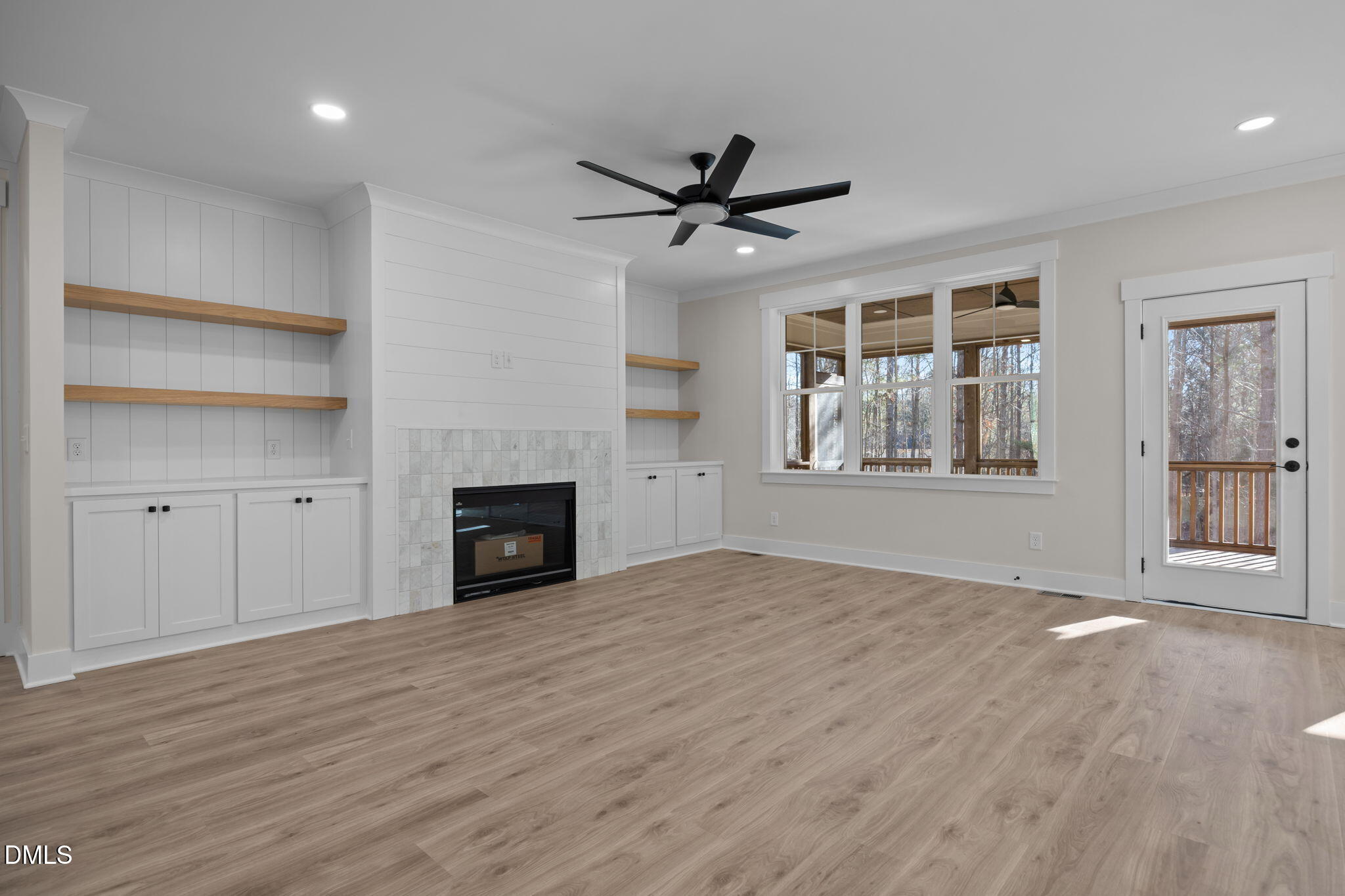 357 Slocum Drive Wendell, NC 27591 - Photo 8 of 48 a view of a livingroom with a fireplace a ceiling fan and windows