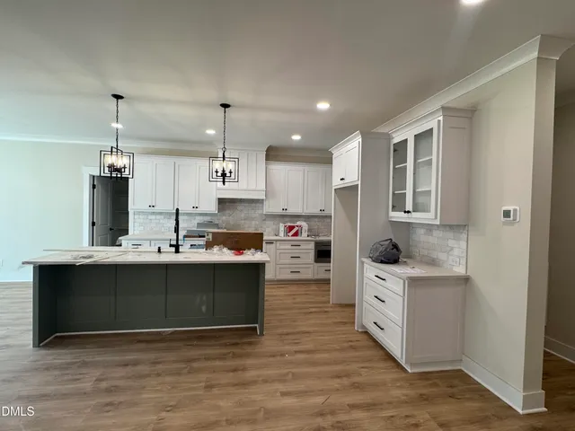a kitchen with stainless steel appliances a stove and cabinets