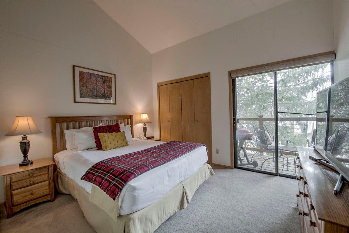 1977 Soda Ridge Road, Unit 1199 Keystone, CO 80435 - Photo 12 of 35 a spacious bedroom with a bed and a large window