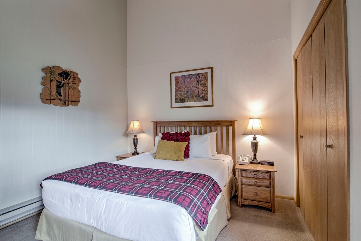 1977 Soda Ridge Road, Unit 1199 Keystone, CO 80435 - Photo 13 of 35 a bedroom with a bed and a night stand