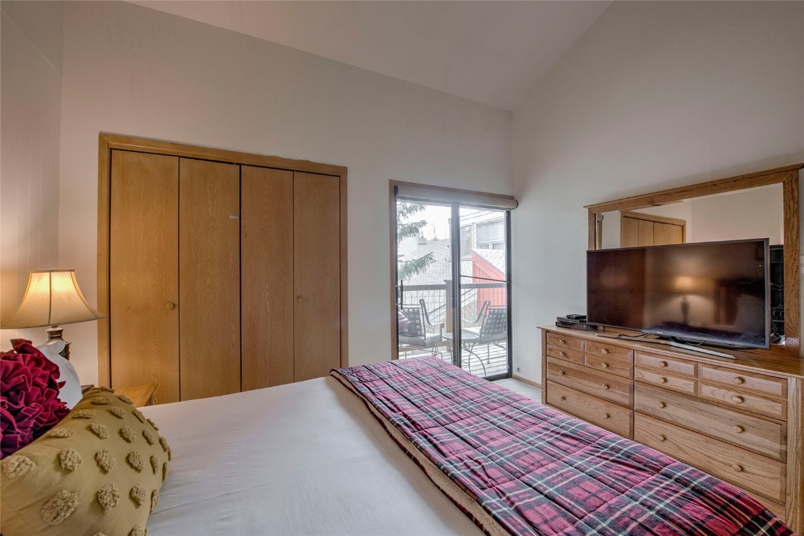 1977 Soda Ridge Road, Unit 1199 Keystone, CO 80435 - Photo 14 of 35 a bedroom with a bed and a flat screen tv