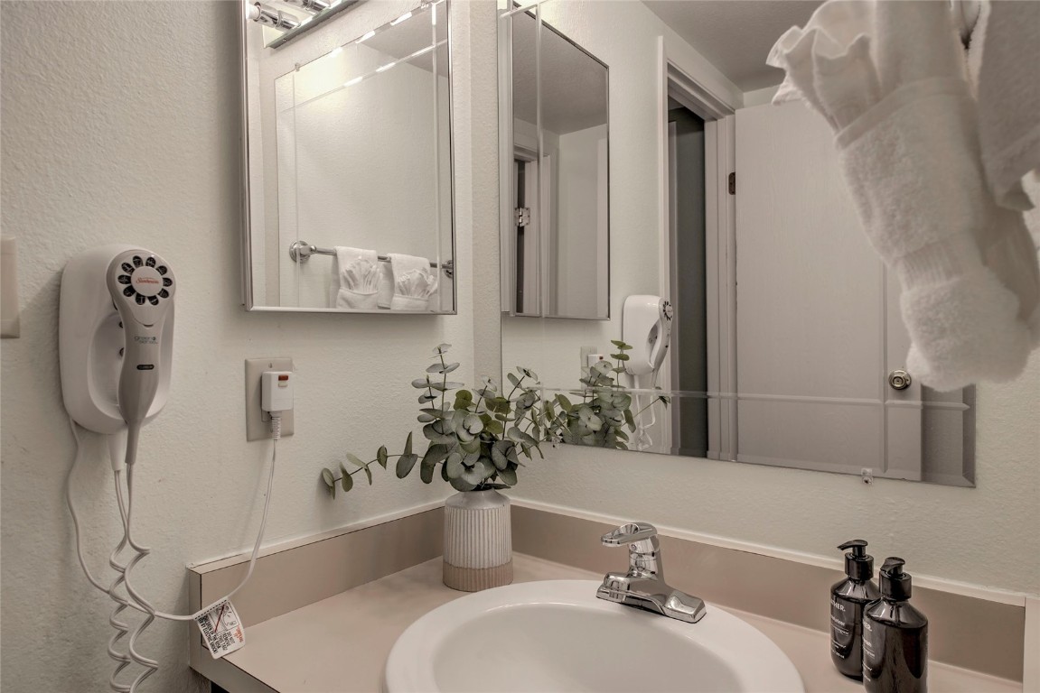 1977 Soda Ridge Road, Unit 1199 Keystone, CO 80435 - Photo 17 of 35 a bathroom with a sink a toilet and mirror