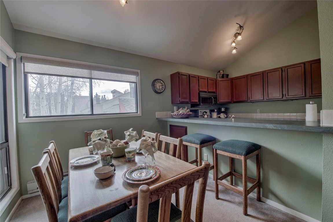 1977 Soda Ridge Road, Unit 1199 Keystone, CO 80435 - Photo 6 of 35 a kitchen with furniture wooden floor dining table and chairs