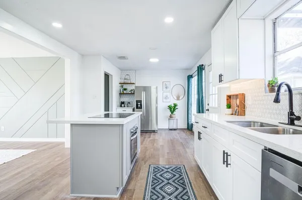 a kitchen with a sink stove and cabinets
