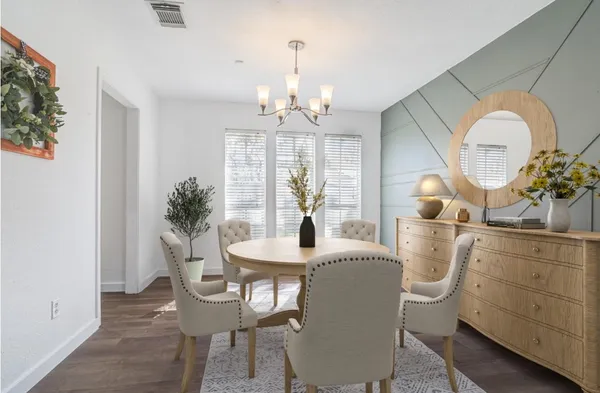 a view of a dining room with furniture and chandelier