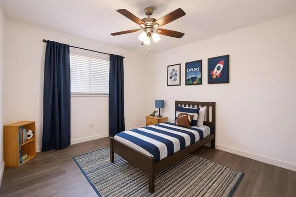 a bedroom with bed and a window
