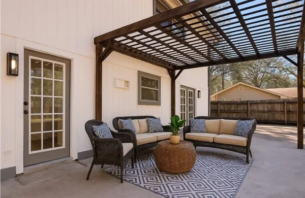 a outdoor living space with furniture and umbrella