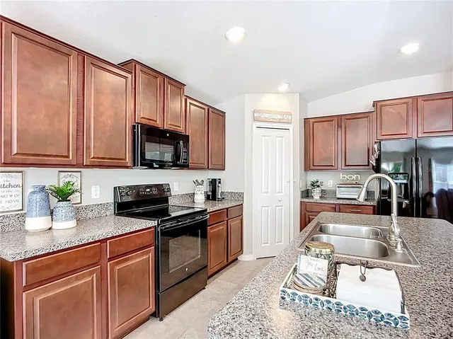 a spacious bedroom with a bed and a chandelier