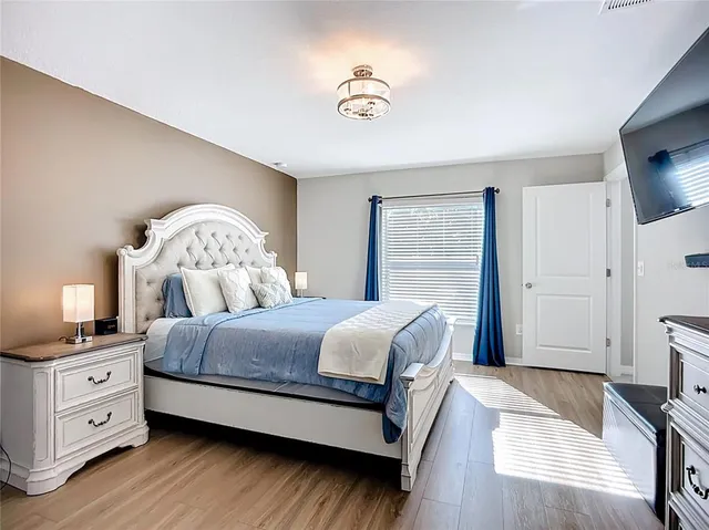 a en suite bathroom with a granite countertop sink and a mirror