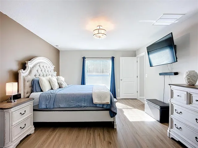 a view of a livingroom with wooden floor and staircase