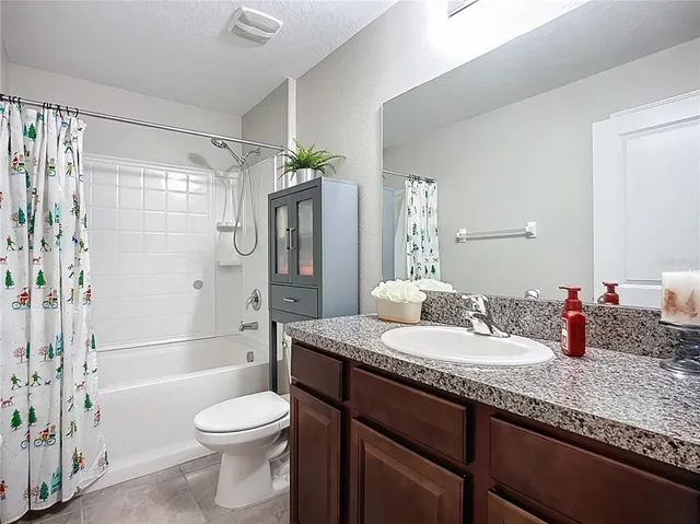 an aerial view of a house with a yard and seating space