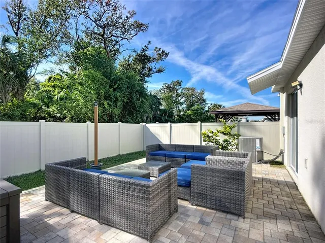 a front view of a house with lots of trees around