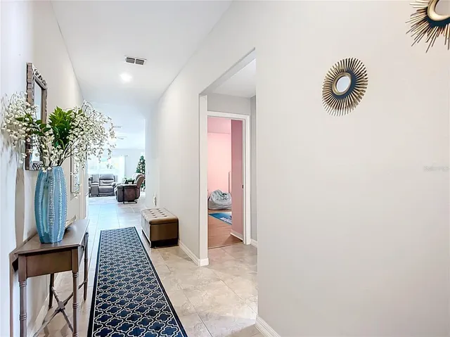 a living room with furniture ceiling fan and a window