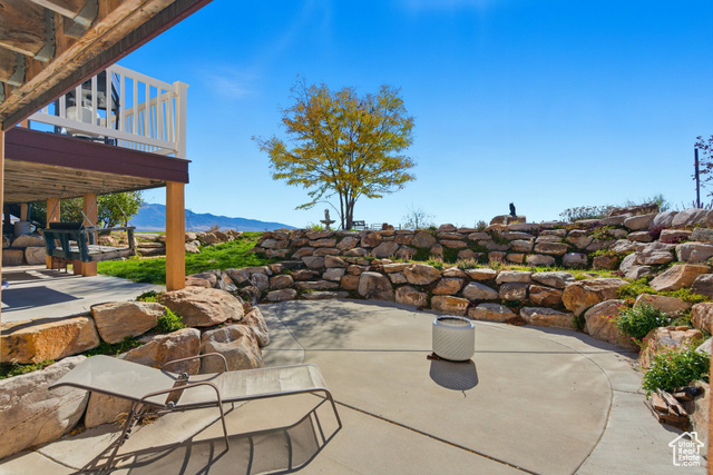 4768 East Hickman Canyon Road Stockton, UT 84071 - Photo 59 of 85 View of patio featuring a mountain view.