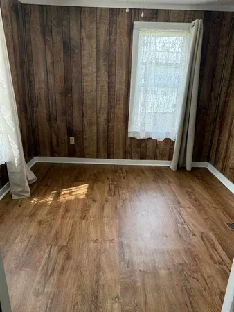a view of a door with wooden floor