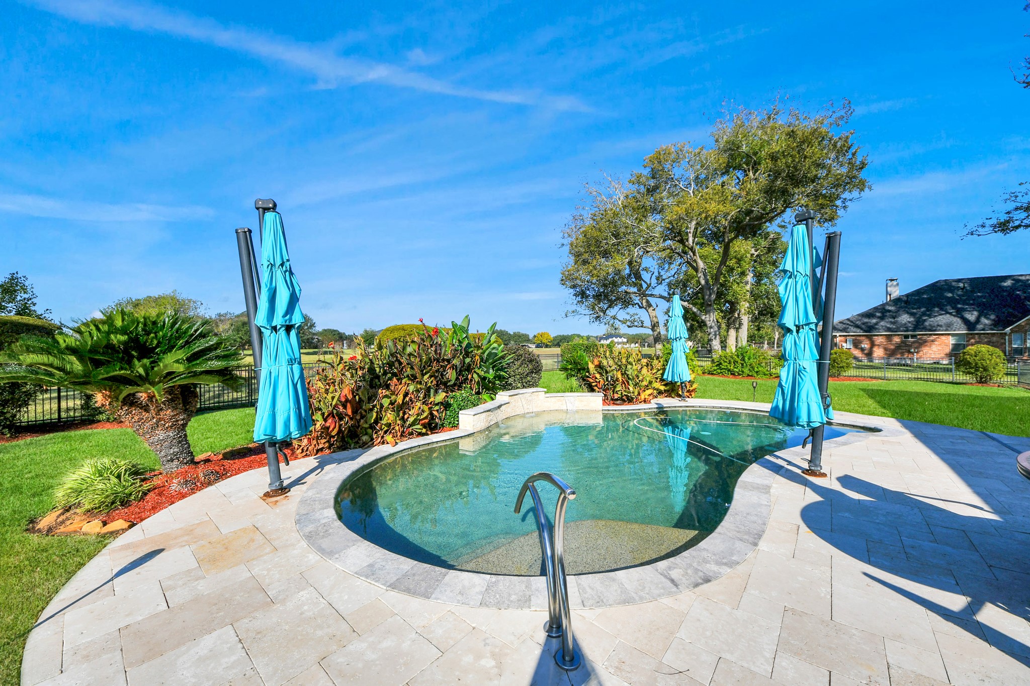 3511 River Bend Drive Rosenberg, TX 77471 - Photo 35 of 50 Refreshing swimming pool with a tranquil cascade fountain and scenic backdrop.