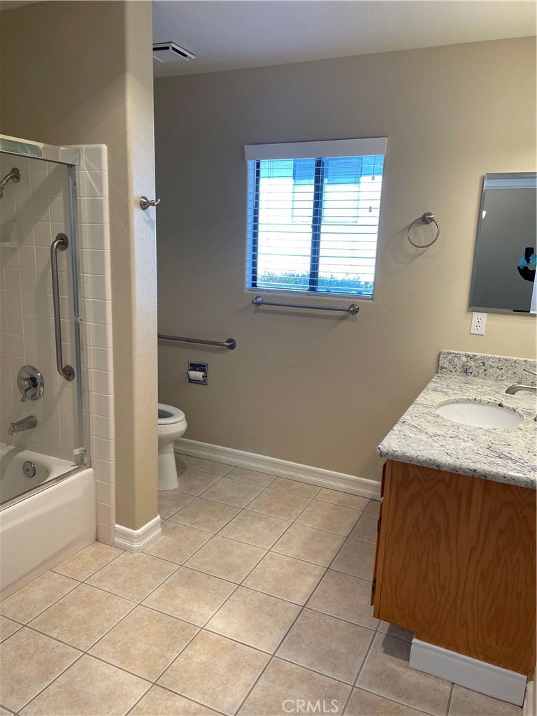 16737 Rickenbacker Circle Riverside, CA 92518 - Photo 5 of 17 a bathroom with a granite countertop sink toilet and shower
