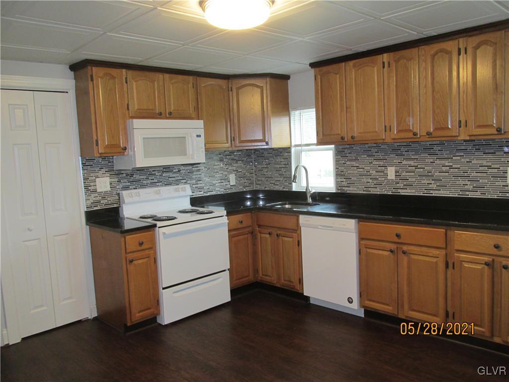 691 Bok Road Nazareth, PA 18064 - Photo 4 of 24 a kitchen with granite countertop wooden cabinets and white appliances