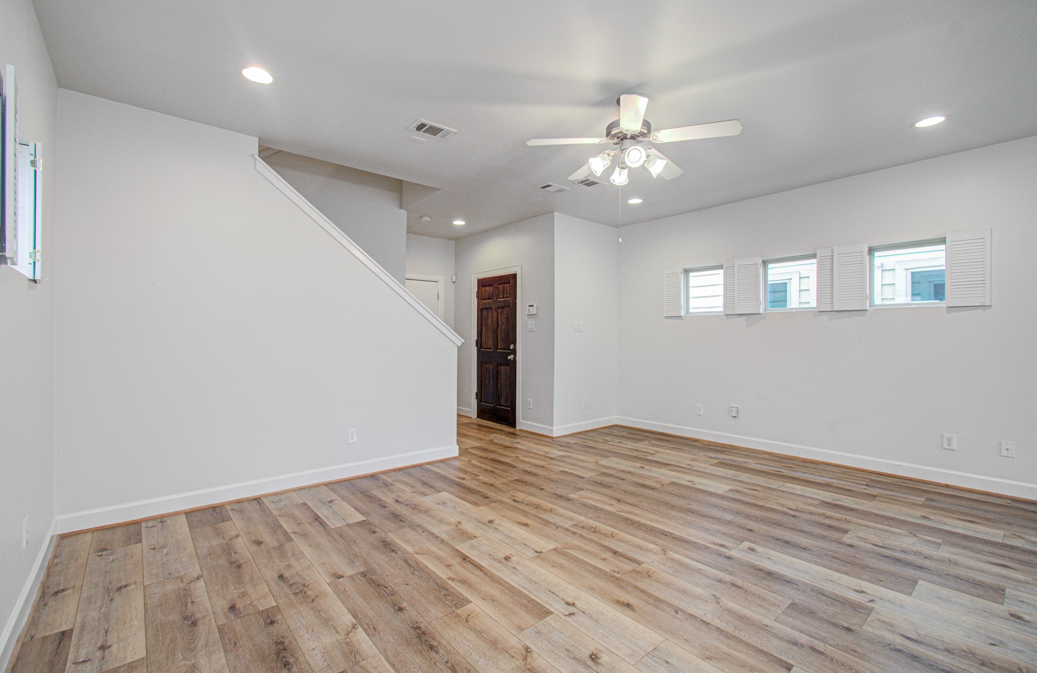 624 East 39th Street Houston, TX 77022 - Photo 10 of 37 a view of an empty room with wooden floor and a ceiling fan