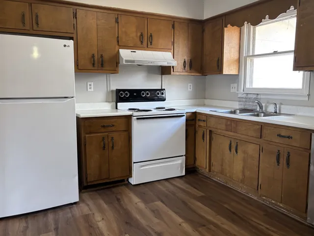 a kitchen with a stove a sink and a refrigerator