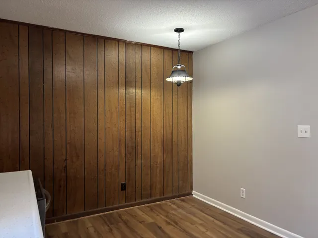 an empty room with wooden floor