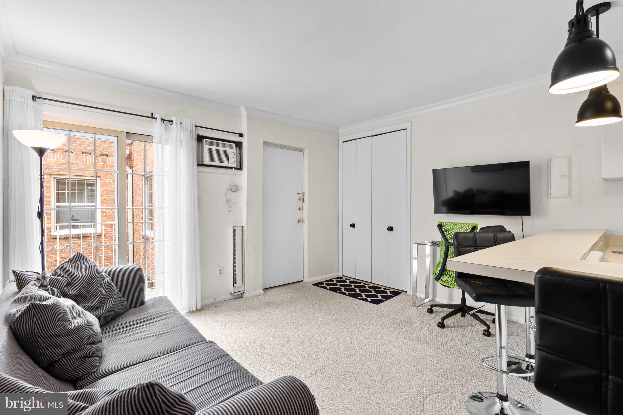 2515 P Street Northwest, Unit 302 Washington, DC 20007 - Photo 11 of 27 a living room with furniture and a flat screen tv