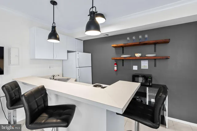 a kitchen with a stove a refrigerator and a dining table