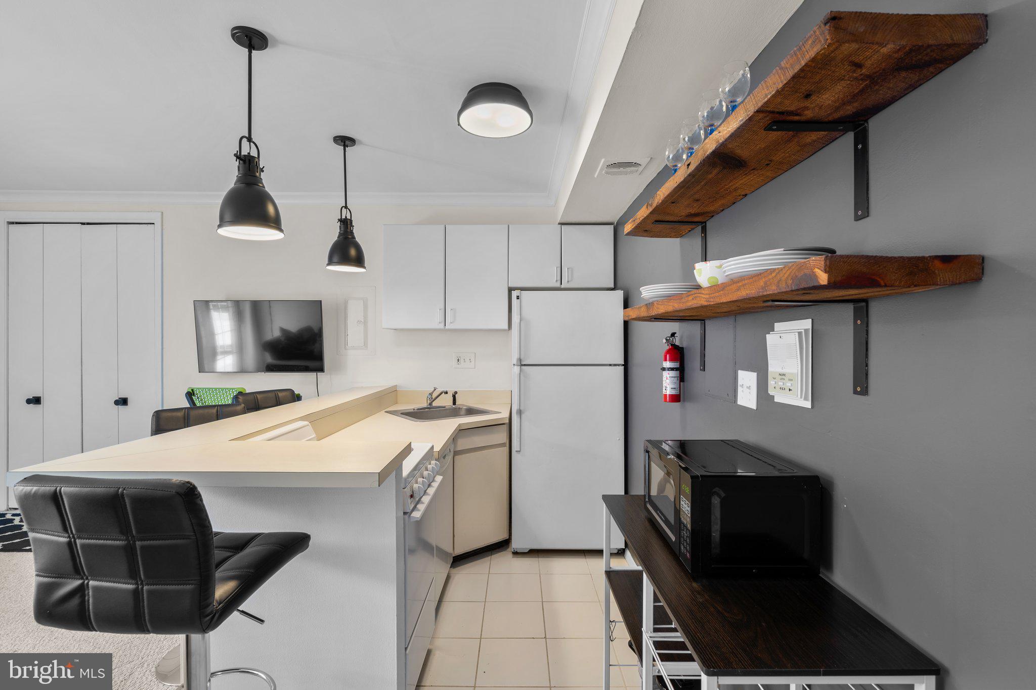 2515 P Street Northwest, Unit 302 Washington, DC 20007 - Photo 13 of 27 a kitchen that has a microwave a stove and a refrigerator