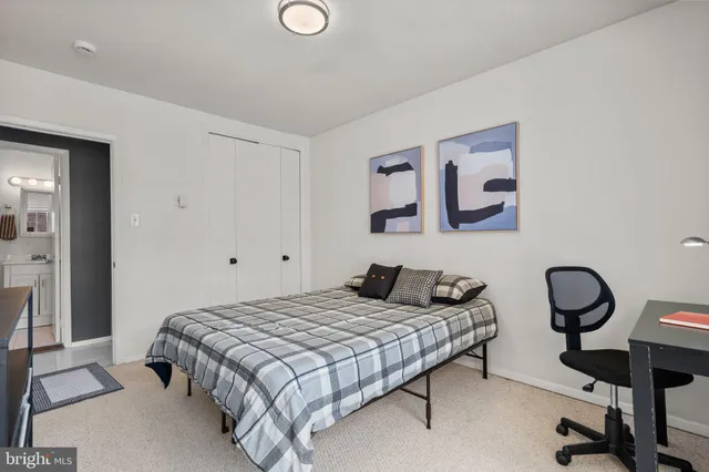 a bedroom with a bed and lamp