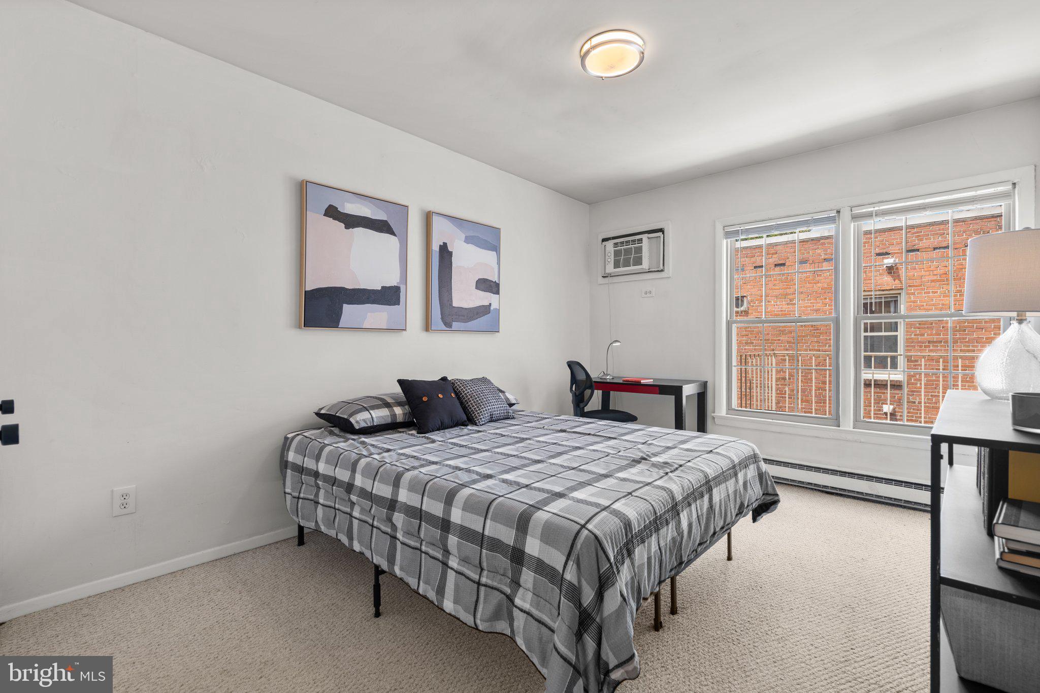 2515 P Street Northwest, Unit 302 Washington, DC 20007 - Photo 19 of 27 a bedroom with a bed and a large window