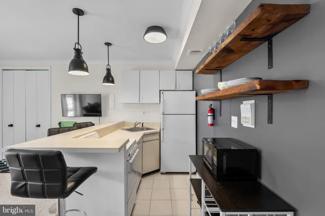 a kitchen that has a microwave a stove and a refrigerator