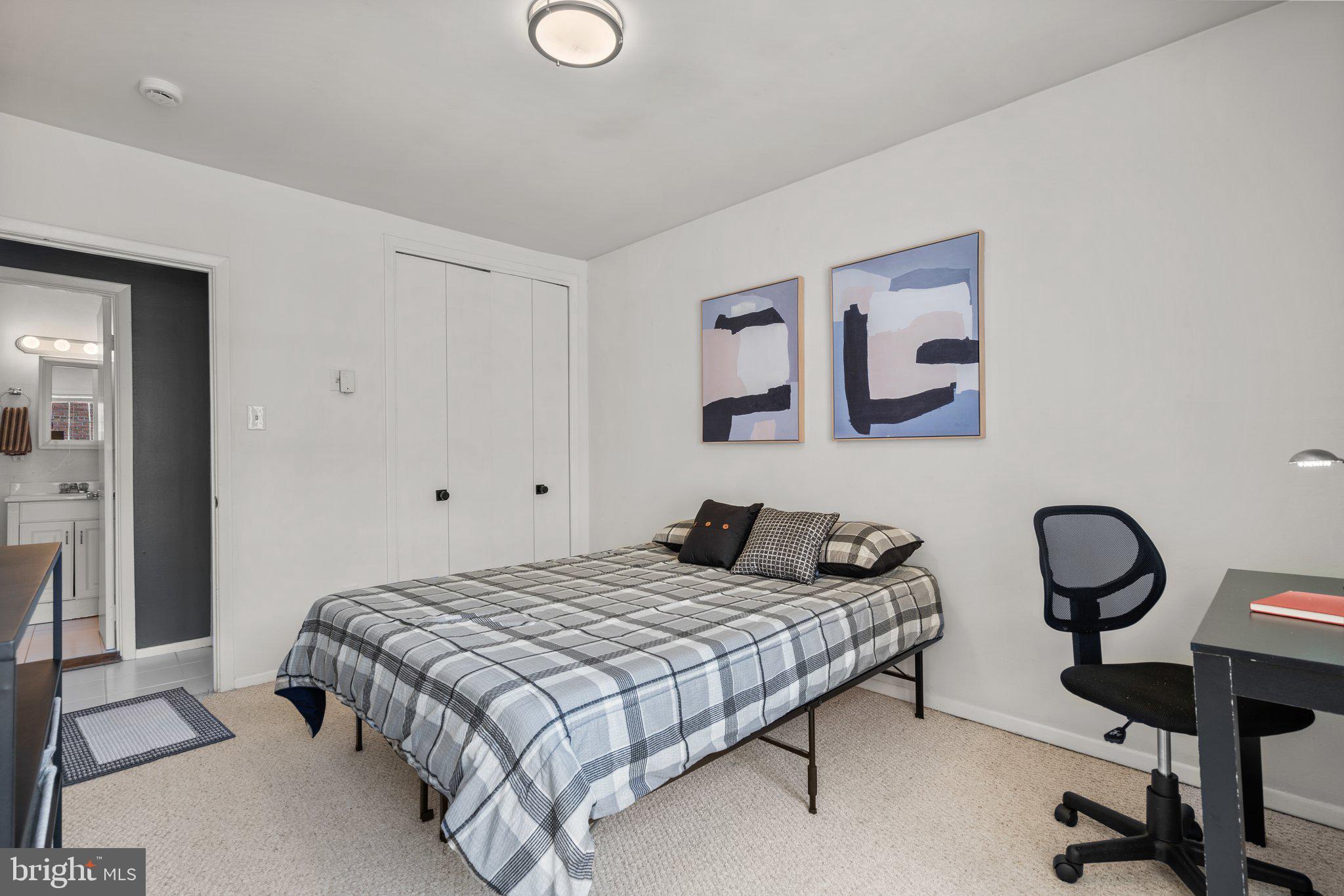 2515 P Street Northwest, Unit 302 Washington, DC 20007 - Photo 20 of 27 a bedroom with a bed and lamp