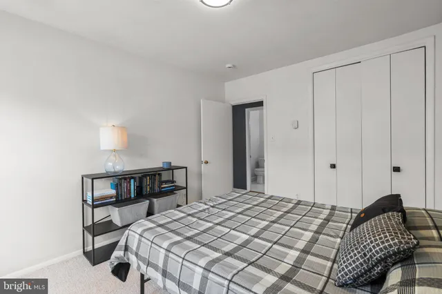 a bedroom with a bed and a bookshelf