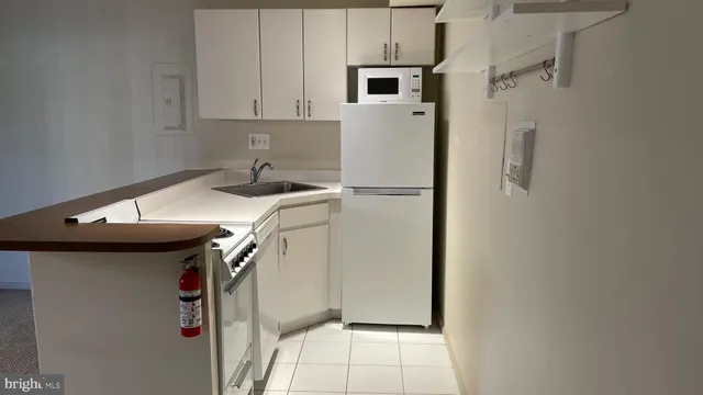 a utility room with cabinets washer and dryer