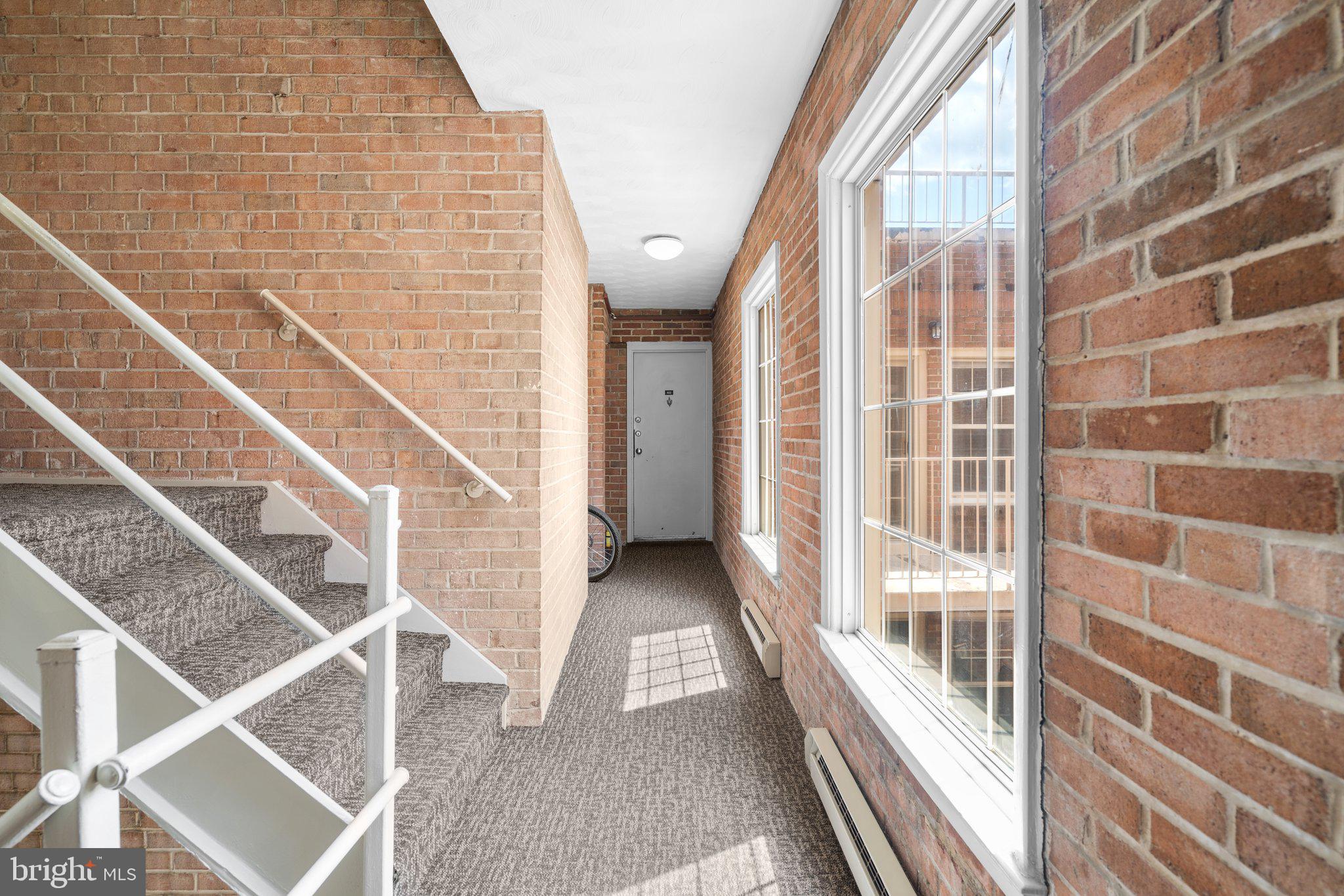 2515 P Street Northwest, Unit 302 Washington, DC 20007 - Photo 6 of 27 a view of a balcony with wooden floor and windows
