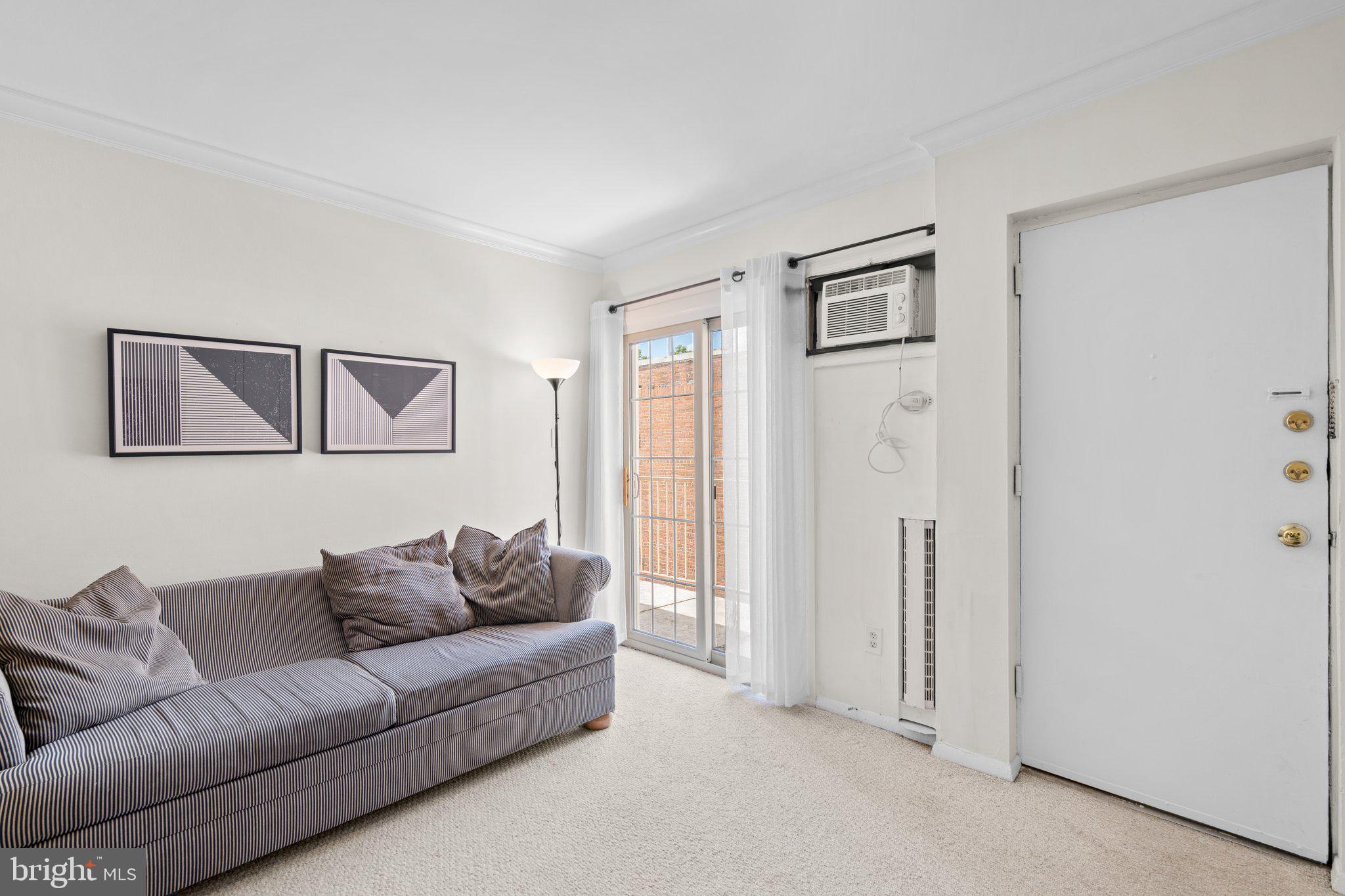 2515 P Street Northwest, Unit 302 Washington, DC 20007 - Photo 10 of 27 a living room with furniture and a window