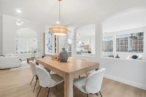 a white bath tub sitting in a bathroom next to a window
